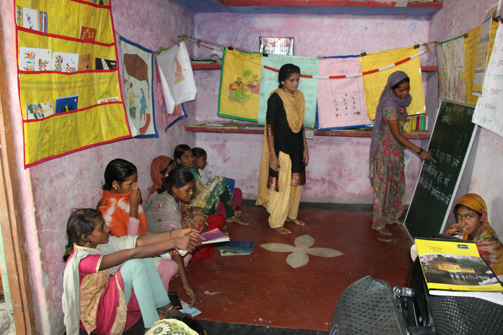 A group of Indian girls engaged in a classroom learning environment indoors.