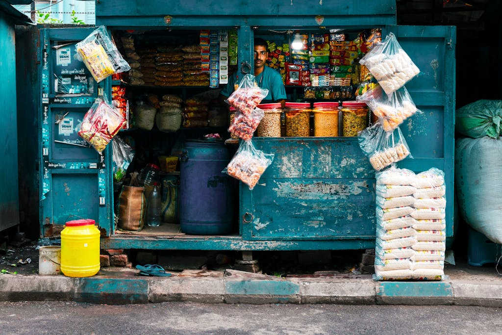 A vibrant street vendor stall in Kolkata selling snacks and essentials.