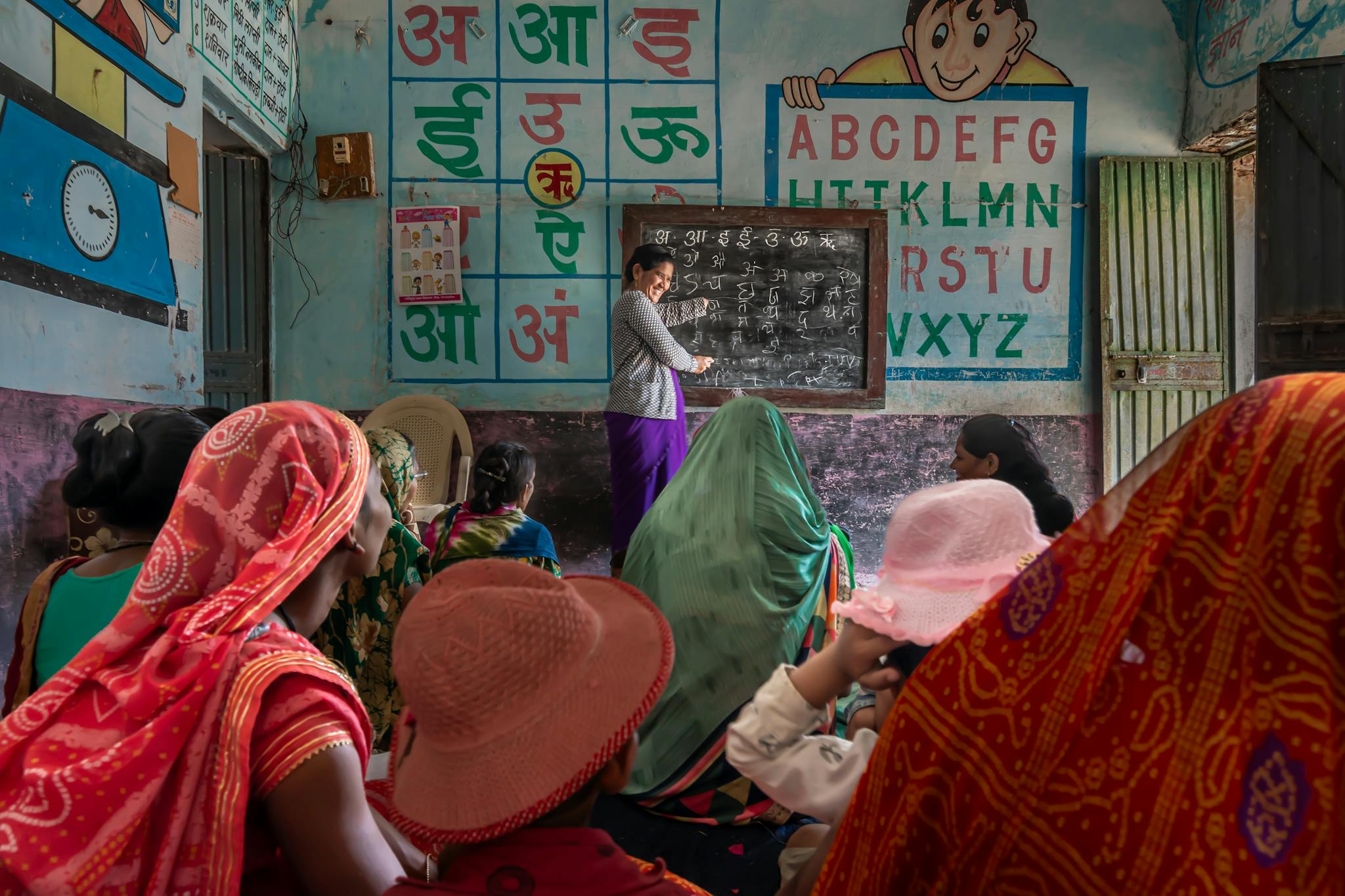 Women attending an educational session in a rural Indian classroom, promoting inclusivity and empowerment.